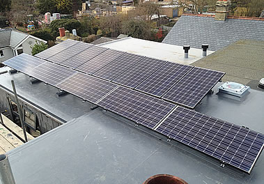Solar panels: Charcoal colour Panasonic PV system as an in-house system with slate roof tiles 